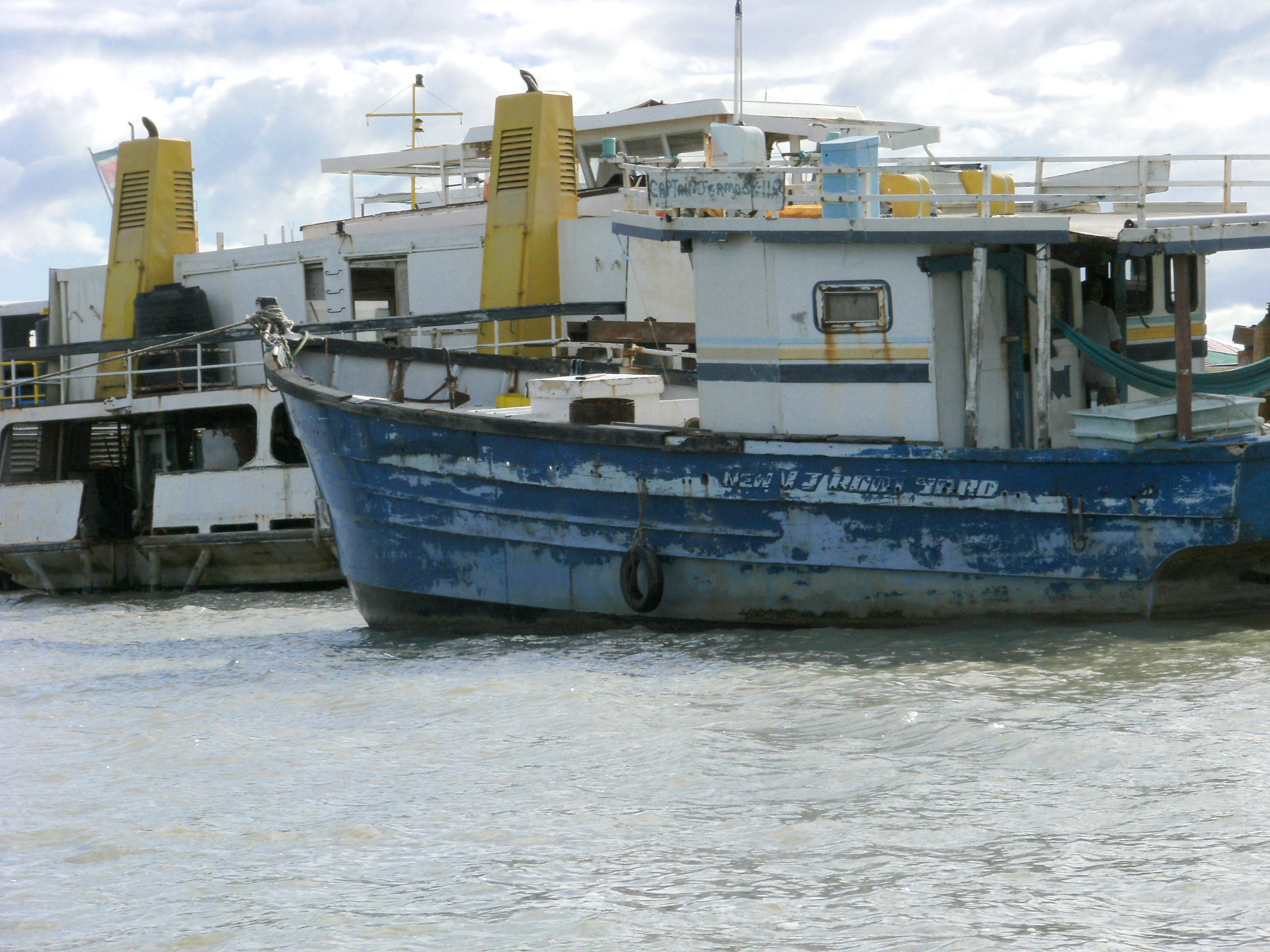 Cargo barges moored on the Suriname River.